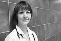 doctor leaning against wall