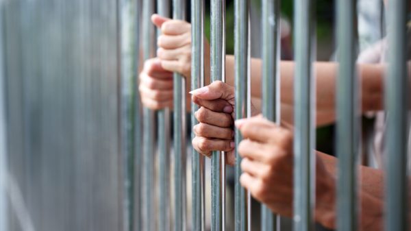 jail bars and hands