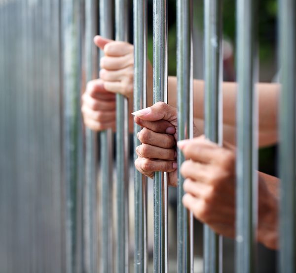jail bars and hands