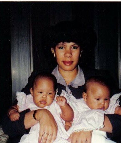 photo of a mother holding two babies