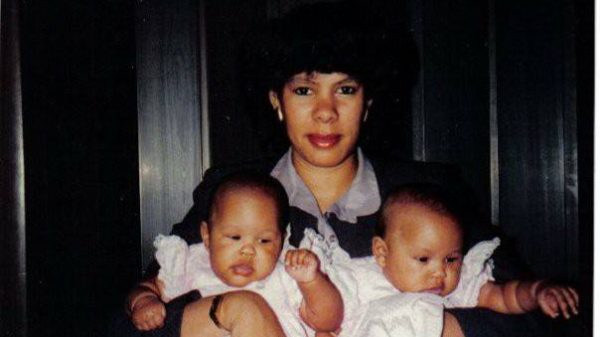 photo of a mother holding two babies