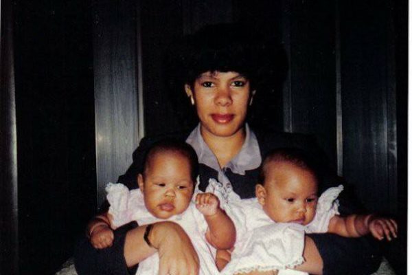 photo of a mother holding two babies