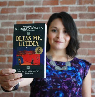 Daisy Vieyra holding a copy of Bless Me, Ultima
