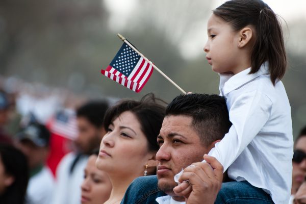 Latino family with American flag.