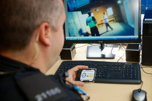 policeman looking at body cam footage