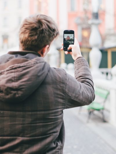 person taking a photo with his mobile phone