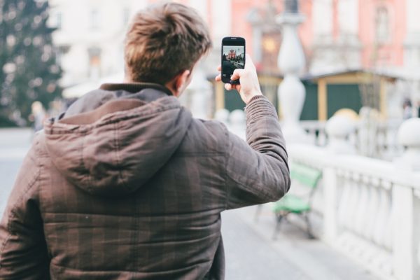 person taking a photo with his mobile phone