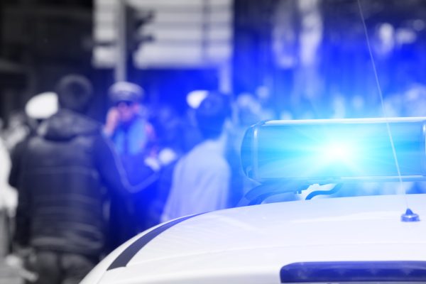 Police vehicle with a crowd in the background