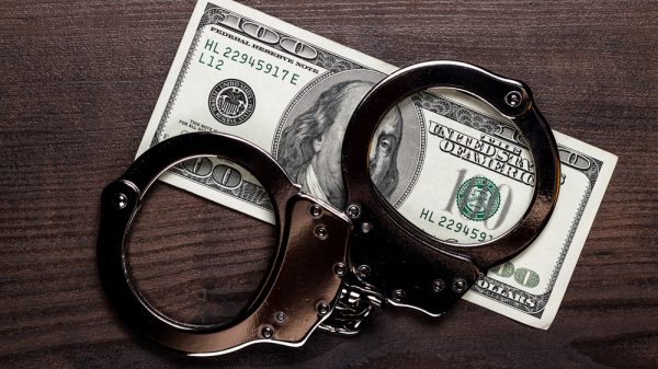 $100 US bill with handcuffs