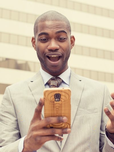 man looking into his smart phone - shutterstock