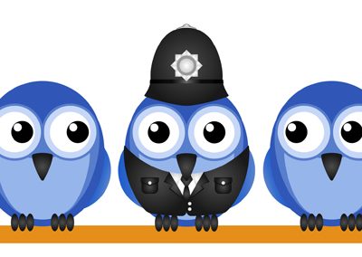 Three blue birds on a line, one is wearing a police uniform