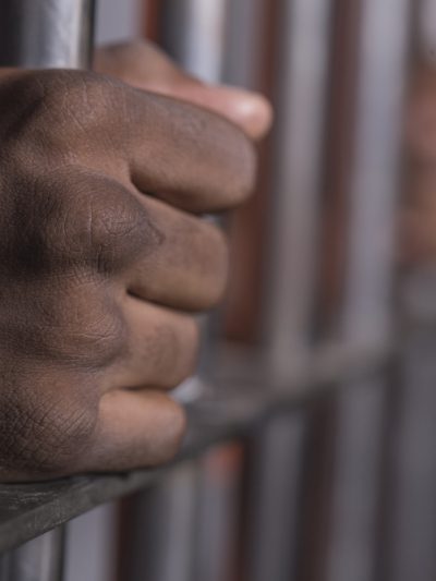 Black hands behind bars