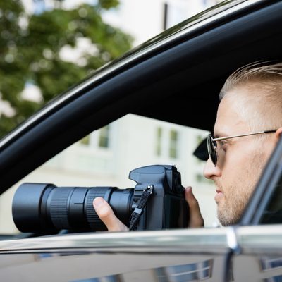 stock photo of a man in a car with a camera