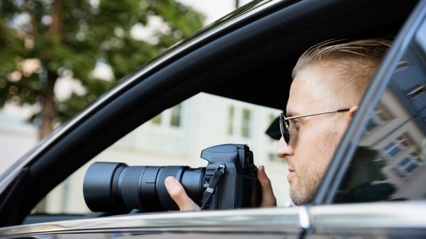 stock photo of a man in a car with a camera