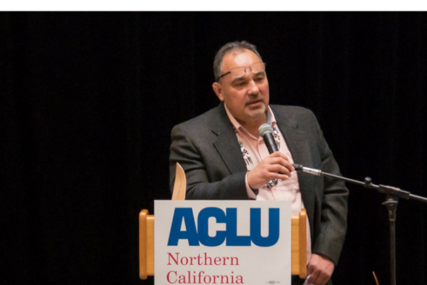 man speaking at podium