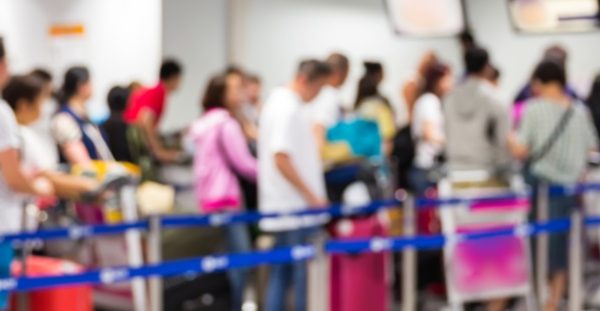 People waiting in line for security screening at an airport