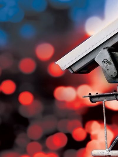 Surveillance camera high above blurred city lights