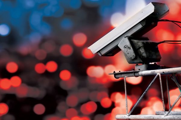 Surveillance camera high above blurred city lights