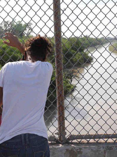 man in front of fence
