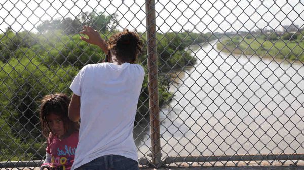 man in front of fence