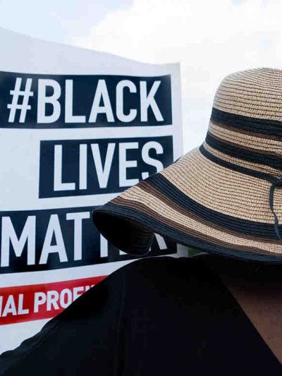 Woman holding black lives matter sign.