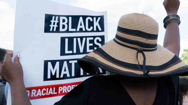 Woman holding black lives matter sign.