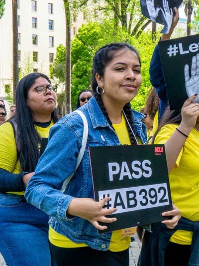 Girl holding #AB 392 sign