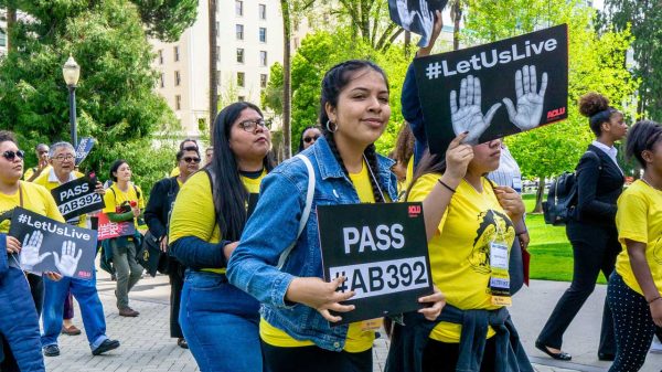 Girl holding #AB 392 sign