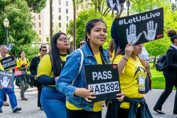 Girl holding #AB 392 sign
