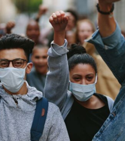 young people wearing masks protesting