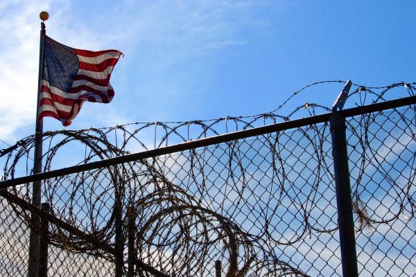 barbed wire fence and american flag