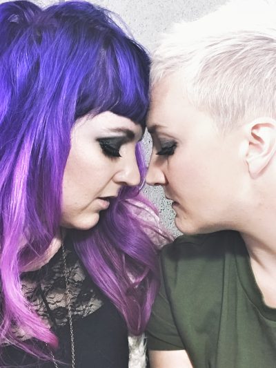 Sera and Frankie of band Unsung Lilly in pose where their foreheads are touching
