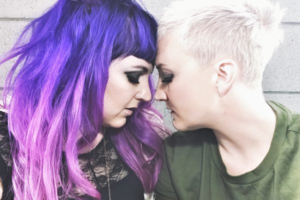 Sera and Frankie of band Unsung Lilly in pose where their foreheads are touching