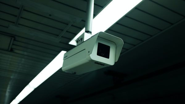 A photograph of a white surveillance camera