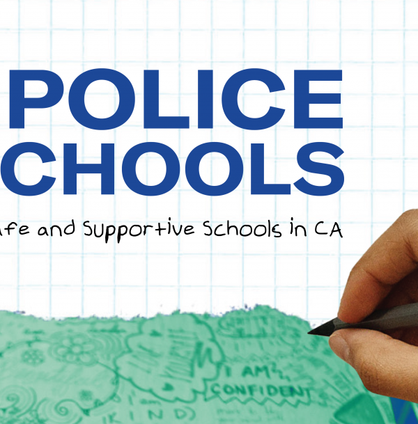 a hand holding a pen on the right and text that reads 'No Police In Schools'