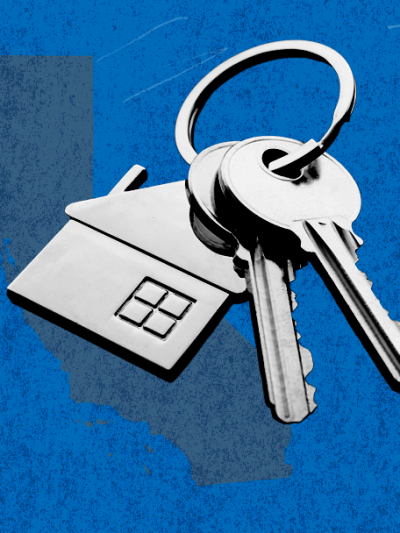 Blue rectangle with a keychain that has a house trinket on it.