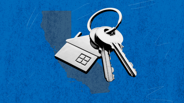 Blue rectangle with a keychain that has a house trinket on it.