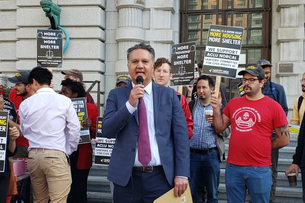 ACLU NorCal Executive Director Abdi Soltani speaks at a rally before a hearing at the Ninth Circuit Court of Appeals on the federal injunction barring San Francisco from citing and arresting unhoused people who have no access to shelter.
