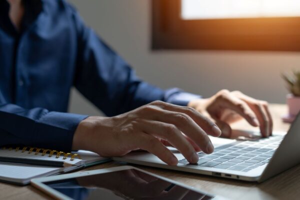man's hand at keyboard