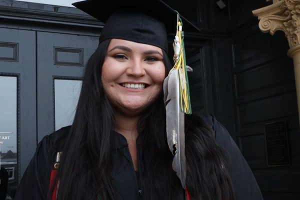 Native student wearing eagle feather