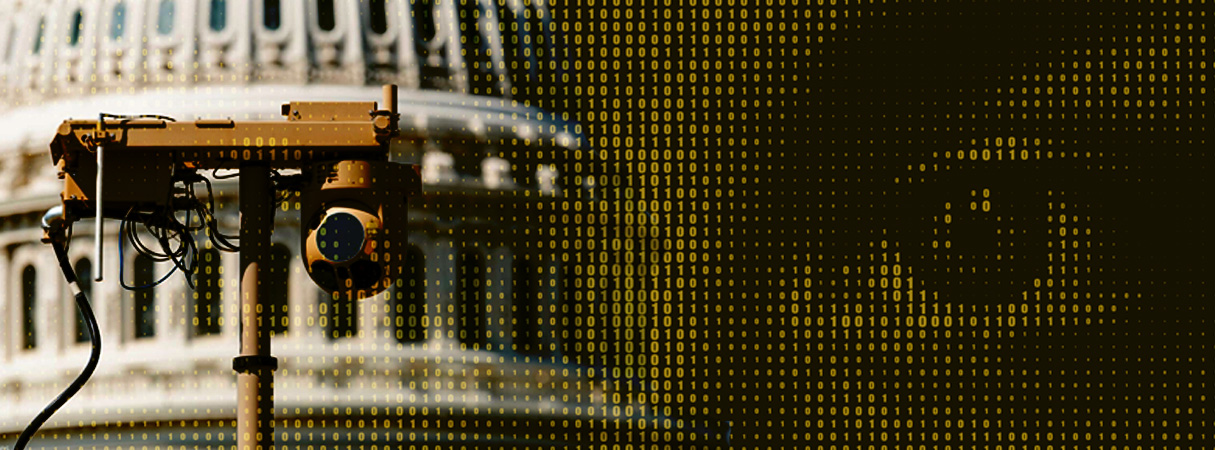 On the left side, there is a picture of a state capitol building with a surveillance cameras. On the right side, an eye apears out of a list of ones and zeros. The whole image has a black and yellow tint.