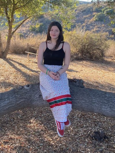 student sitting outside on a tree