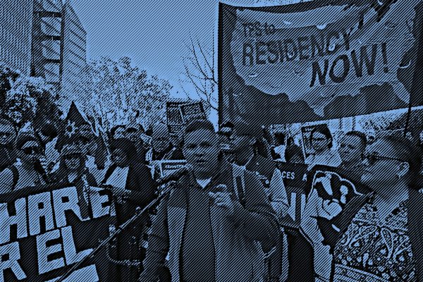 A crowd gathered for a rally in support of TPS holders in San Francisco with a sign reading, "TPS to Residency NOW!"