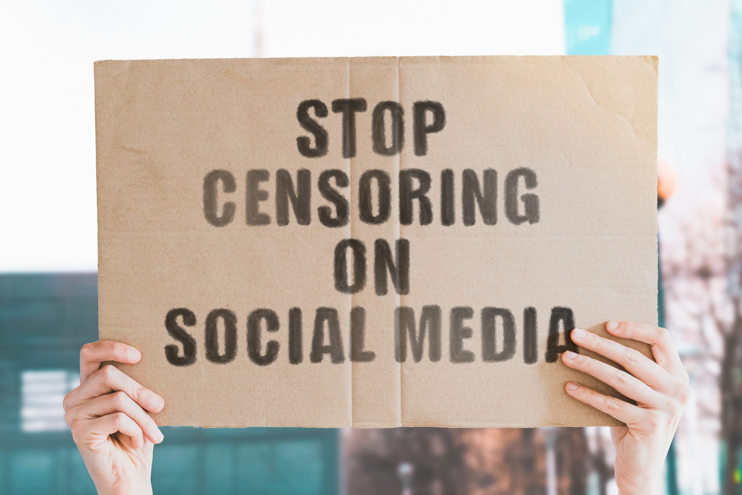 sign saying "stop censoring on social media"