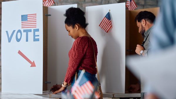 African American woman at voting booth during US elections