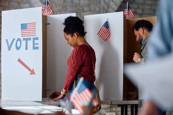 African American woman at voting booth during US elections