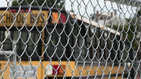School Bus Parked Behind Chain Link Fence