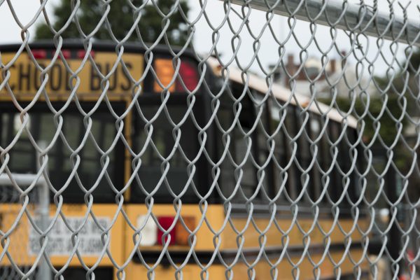 School Bus Parked Behind Chain Link Fence