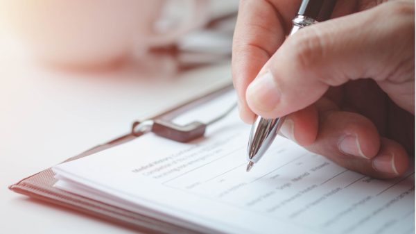 hand filling out a form