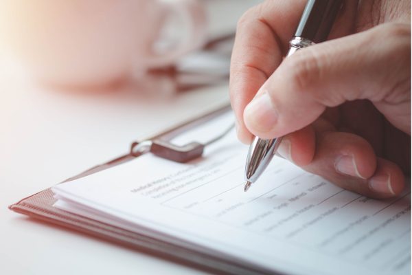 hand filling out a form